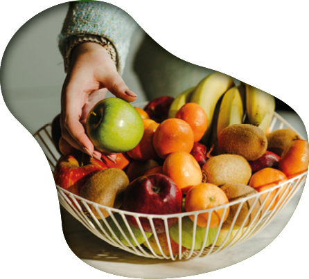 A person is holding a bowl filled with various fruits, including apples, oranges, and bananas. AI generated content