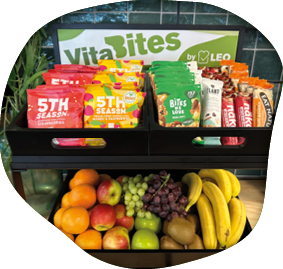A black shelf with a variety of fruits and snacks on display. AI generated content
