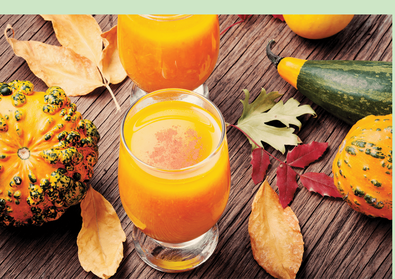 Pumpkin smoothie in a glass on vintage table.Beverage with pumpkins