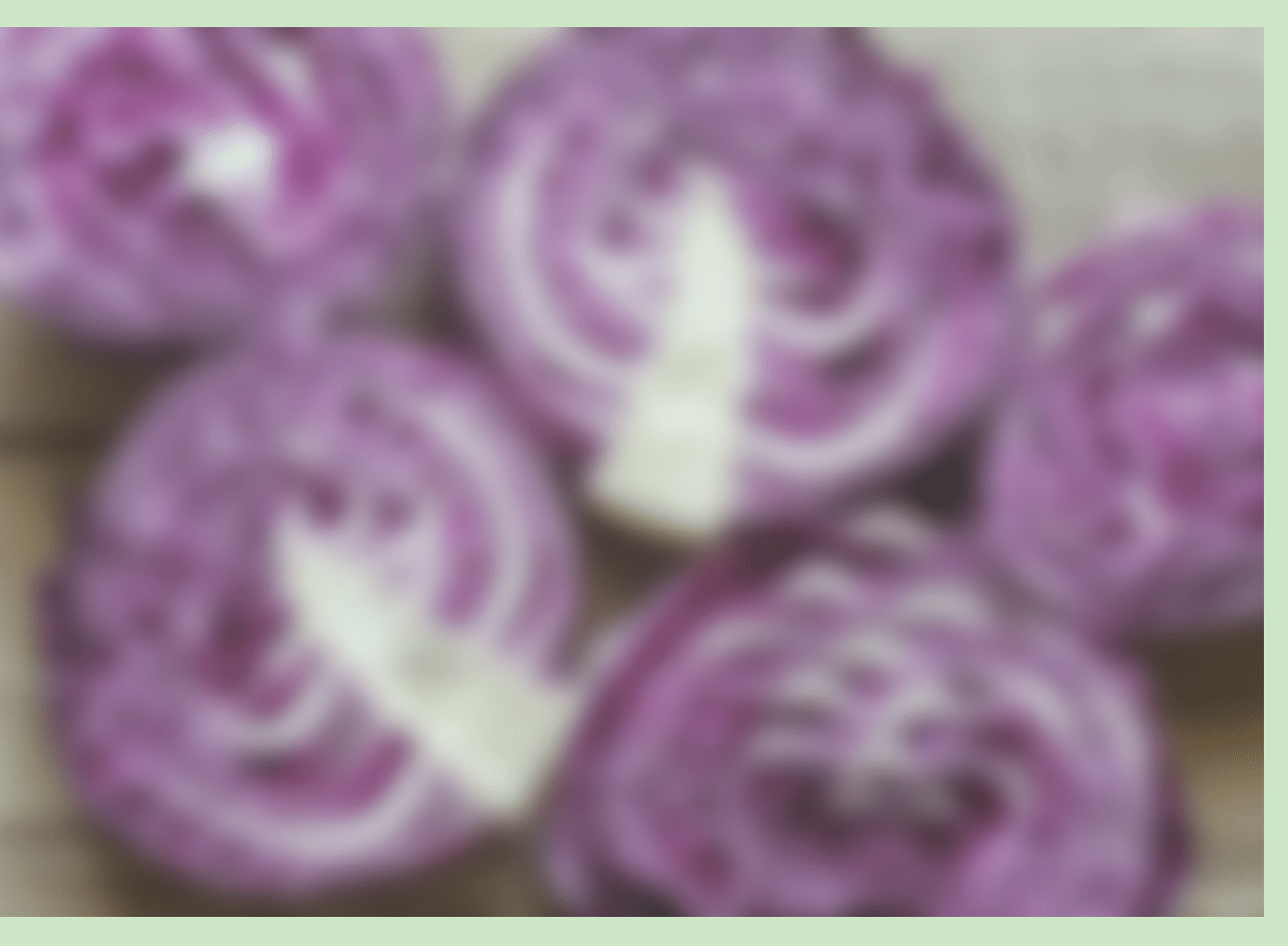Red cabbages on the wooden background