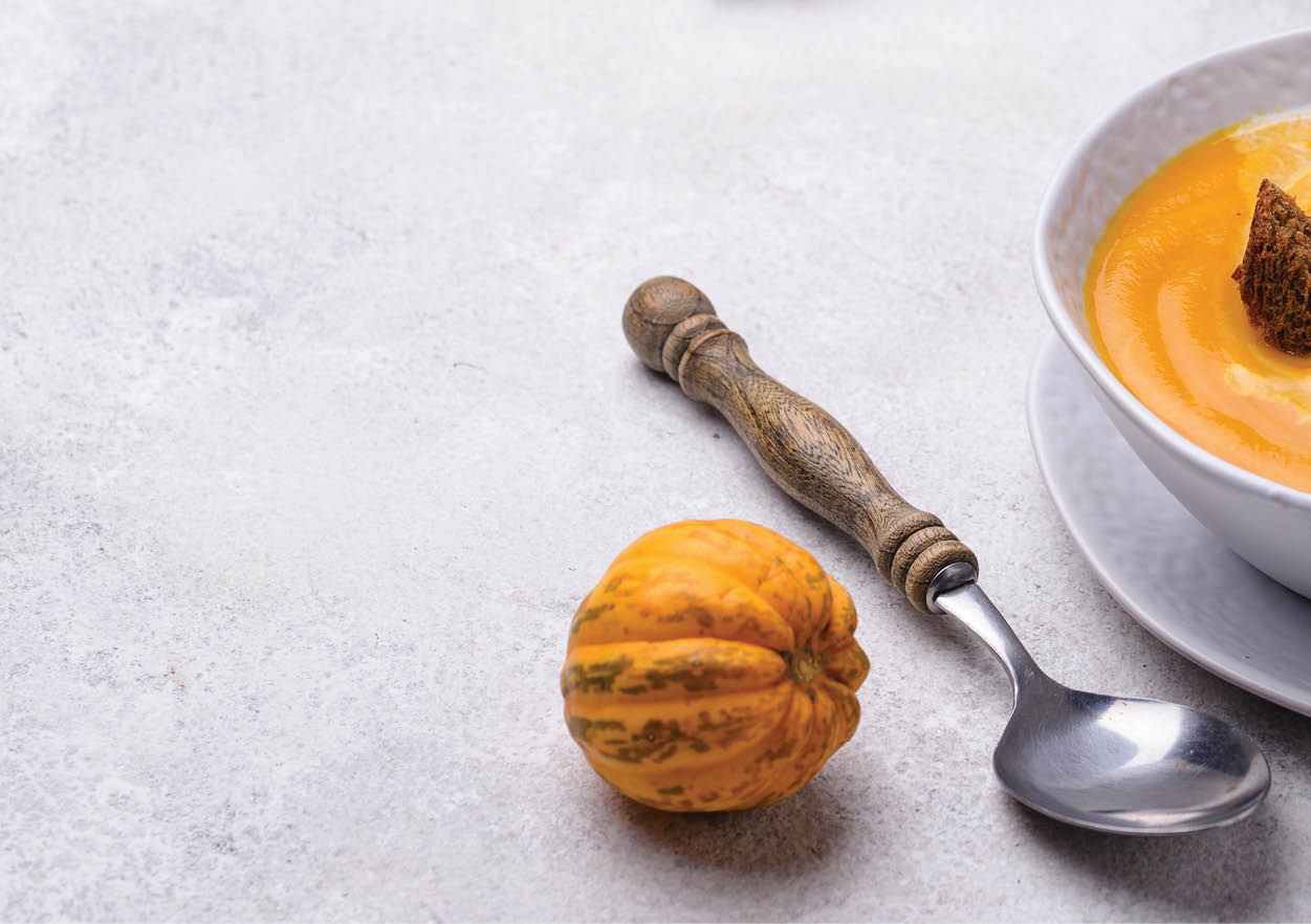 Traditional autumn pumpkin cream soup with sour cream