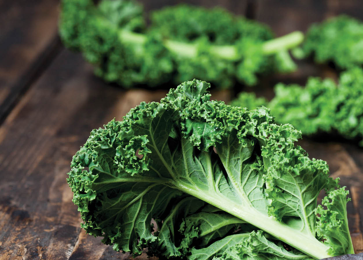 Kale leaves on dark wood
