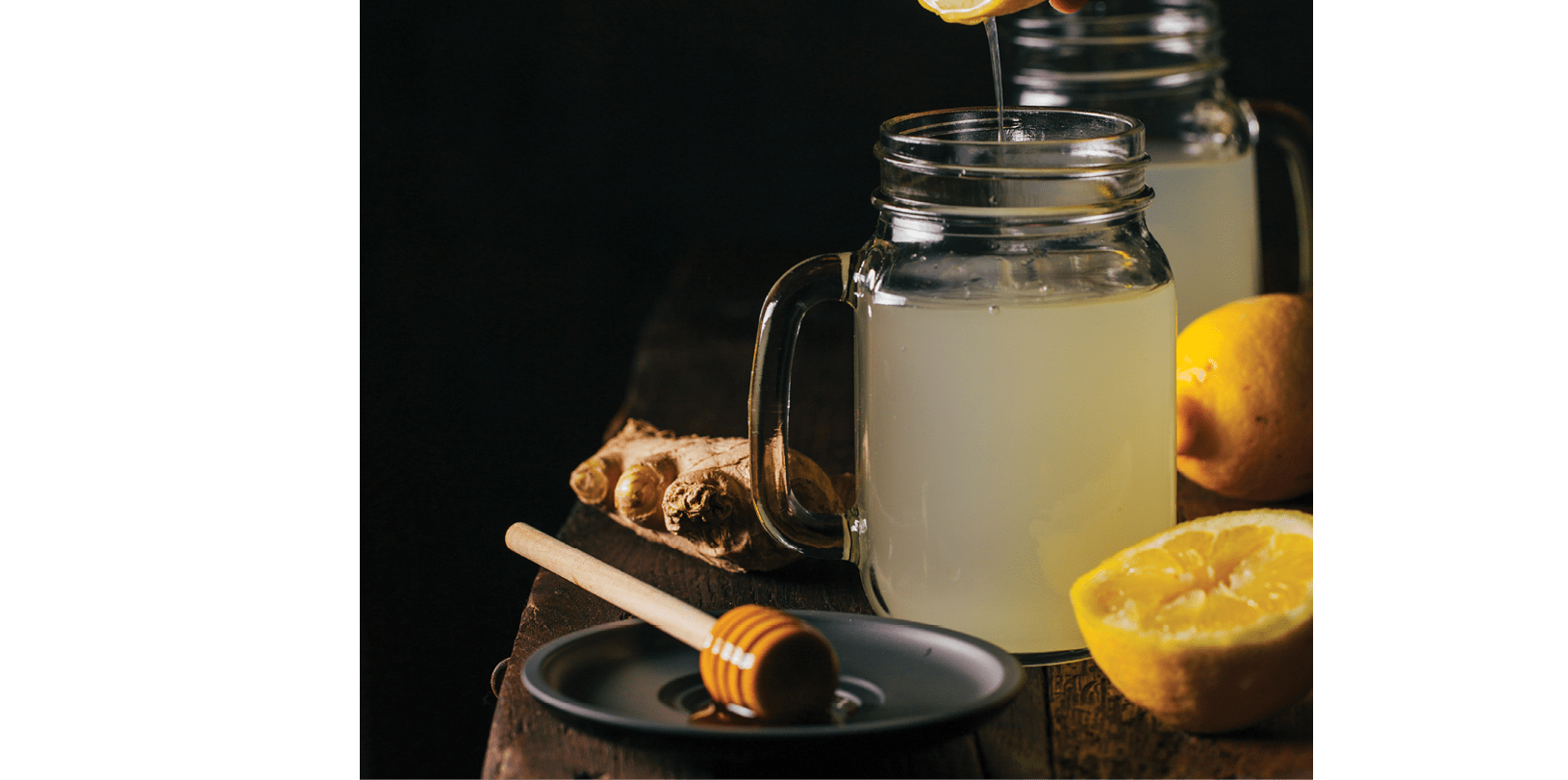 Preparing switchel with lemon juice, ginger and honey