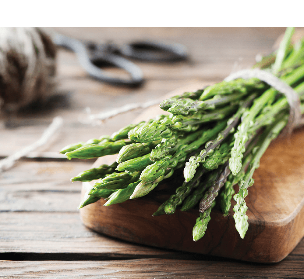 Fresh wild asparagus on the wooden table, selective focus