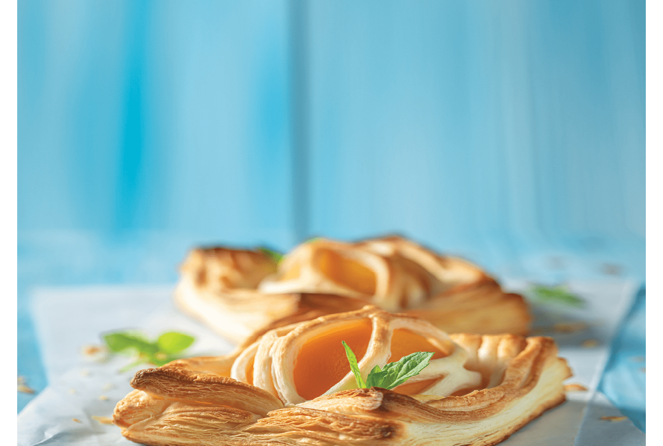 Tasty puff pastry with sugar and peaches. French juicy dessert. French cuisine.