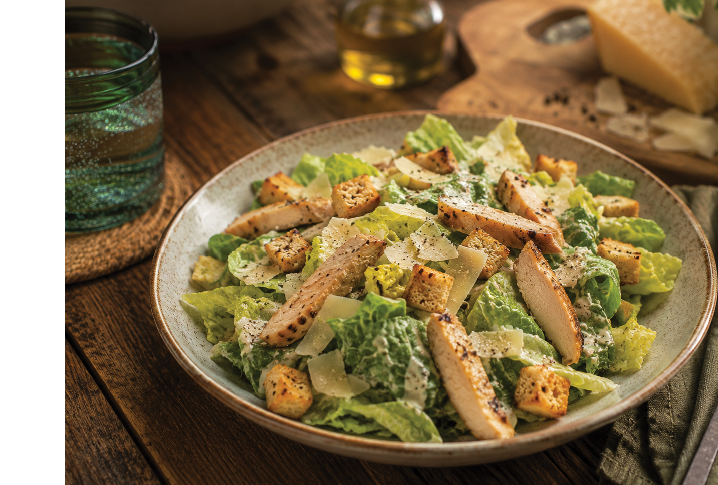 A plate of salad with chicken and cheese. Description generated by AI