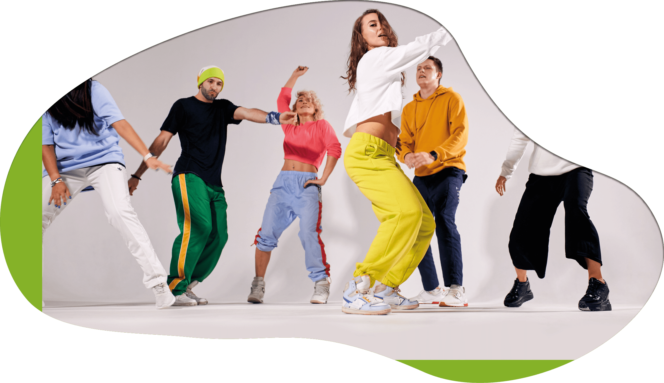group of happy young people dancing cheerfully on stage of dance school studio, female professional trainer showing hip hop movie, break dancers preparing for festival, side shot