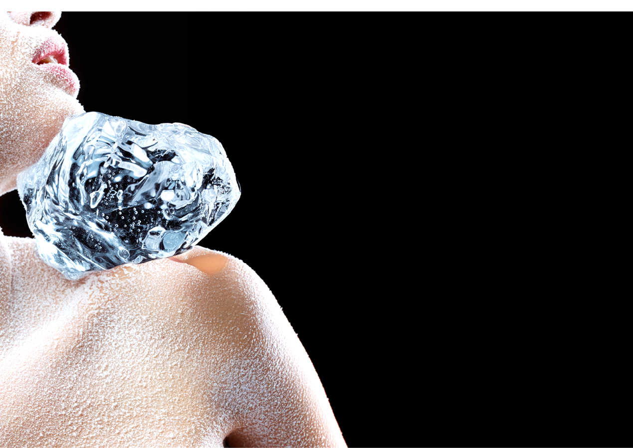 Frosted female holding a piece of ice on a shoulder.