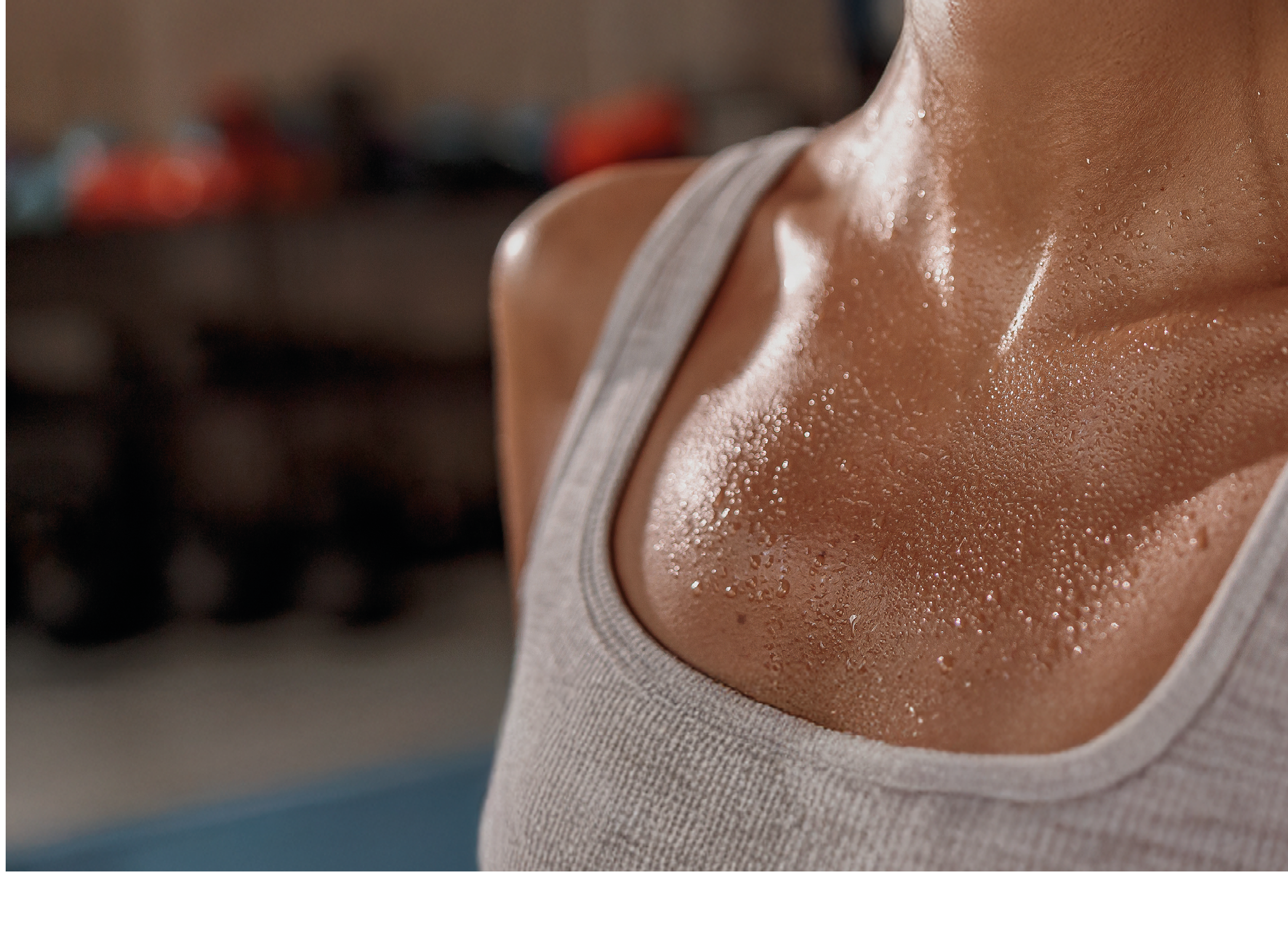 Close up of shoulders and neck fit female with sweat on skin after workout