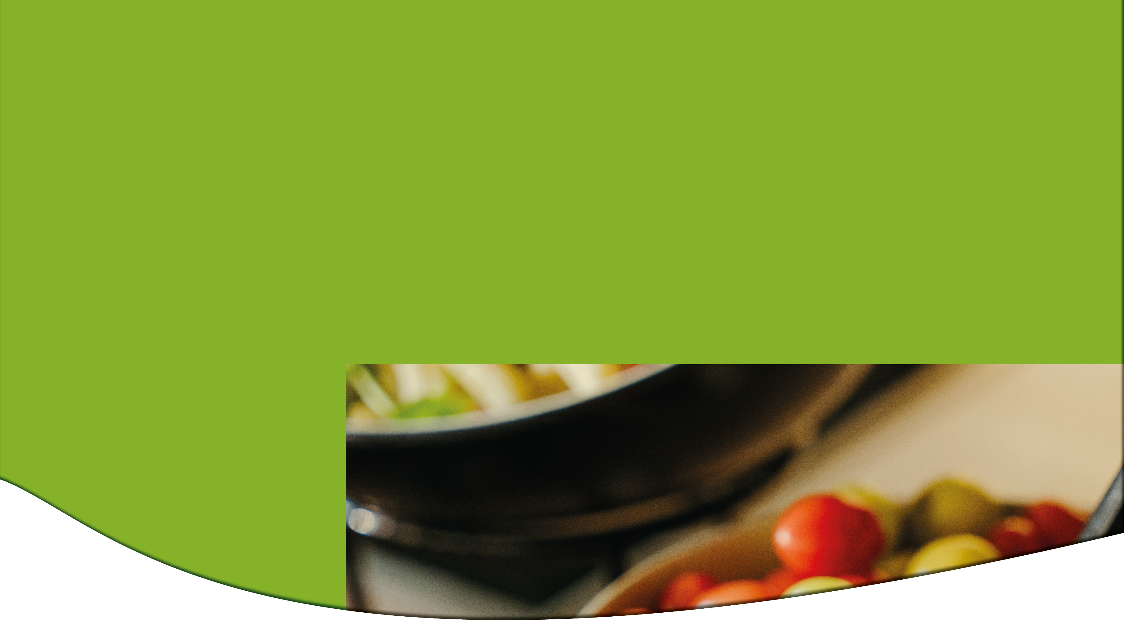 A close-up of a bowl containing green and red olives with black chopsticks resting on the edge. Description generated by AI