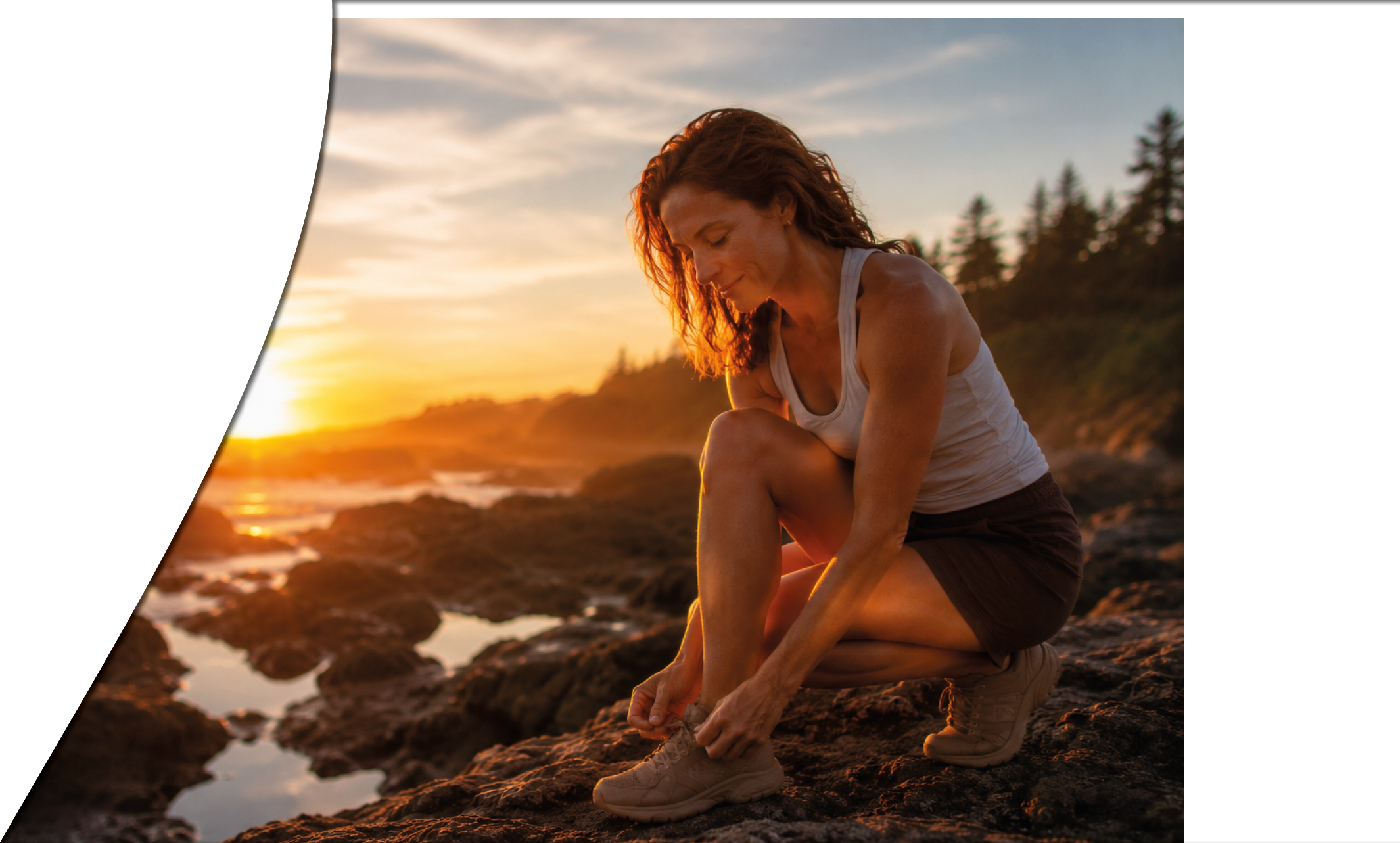 A woman is sitting on a rock and looking at her shoes. Description generated by AI