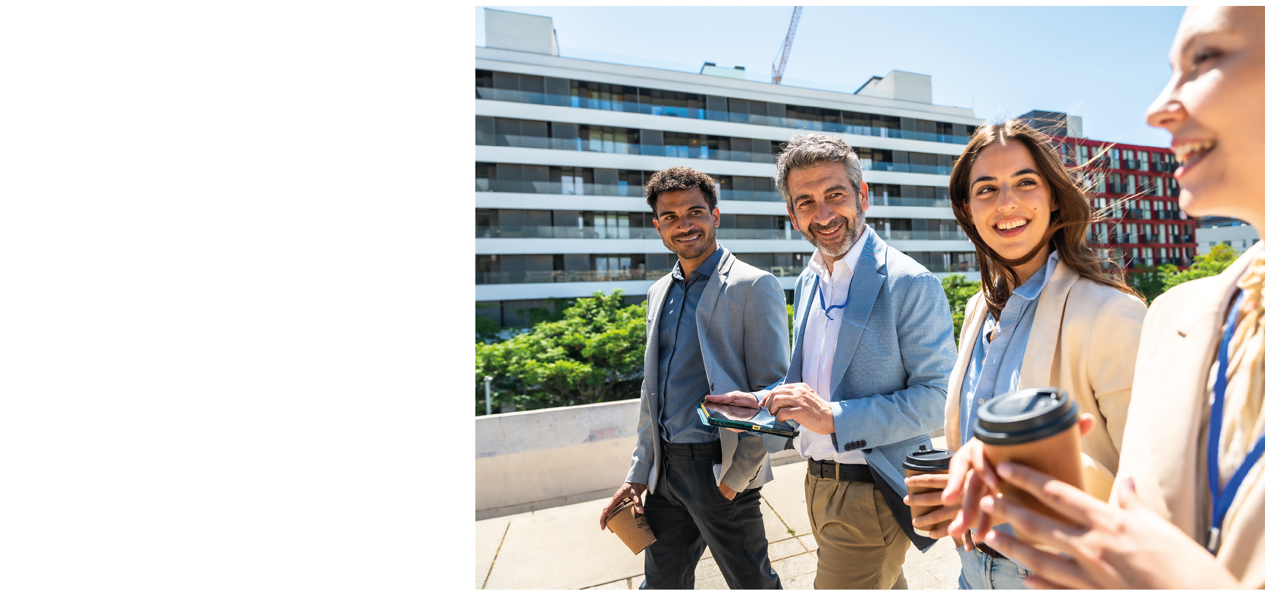 Three people standing on a sidewalk. Description generated by AI