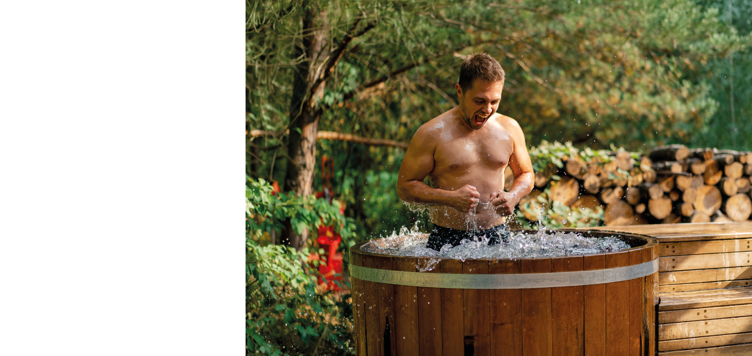 A man is standing in a wooden tub filled with water. Description generated by AI