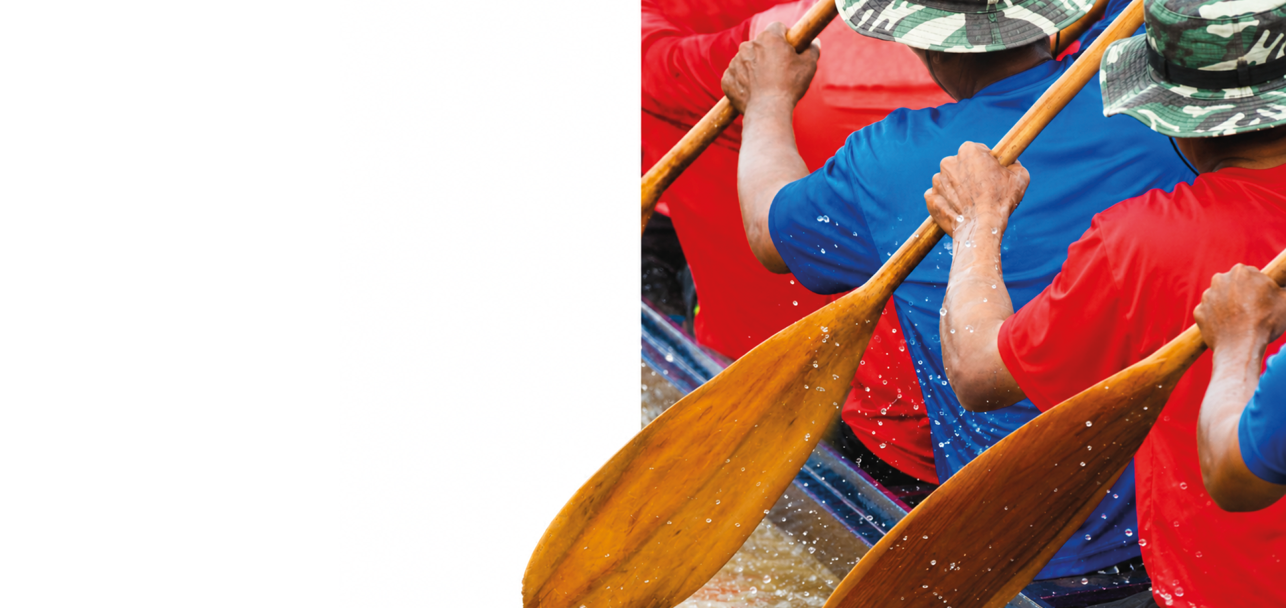 A group of people rowing a boat. Description generated by AI