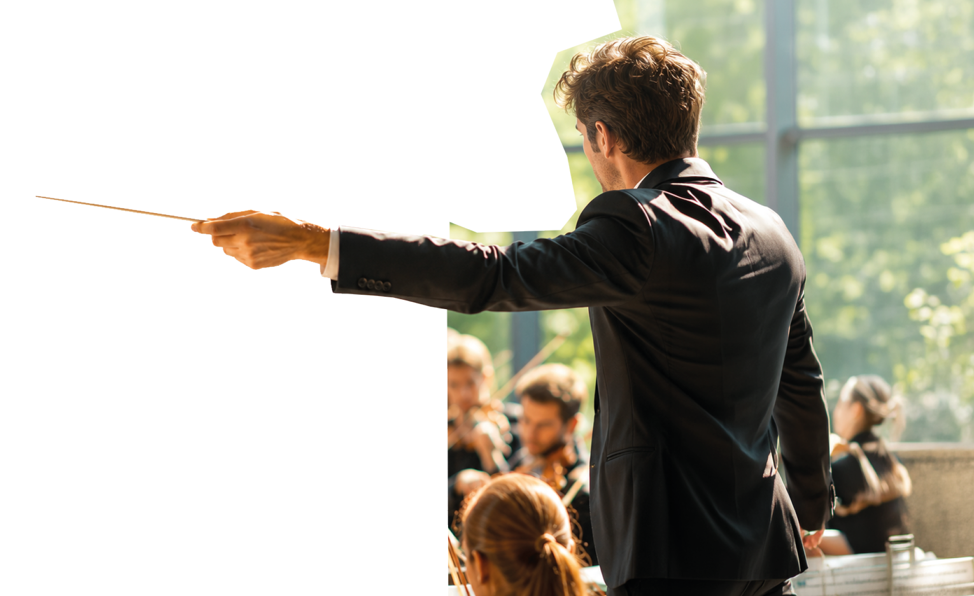 A man in a black suit and tie is pointing at a white sheet of paper. Description generated by AI