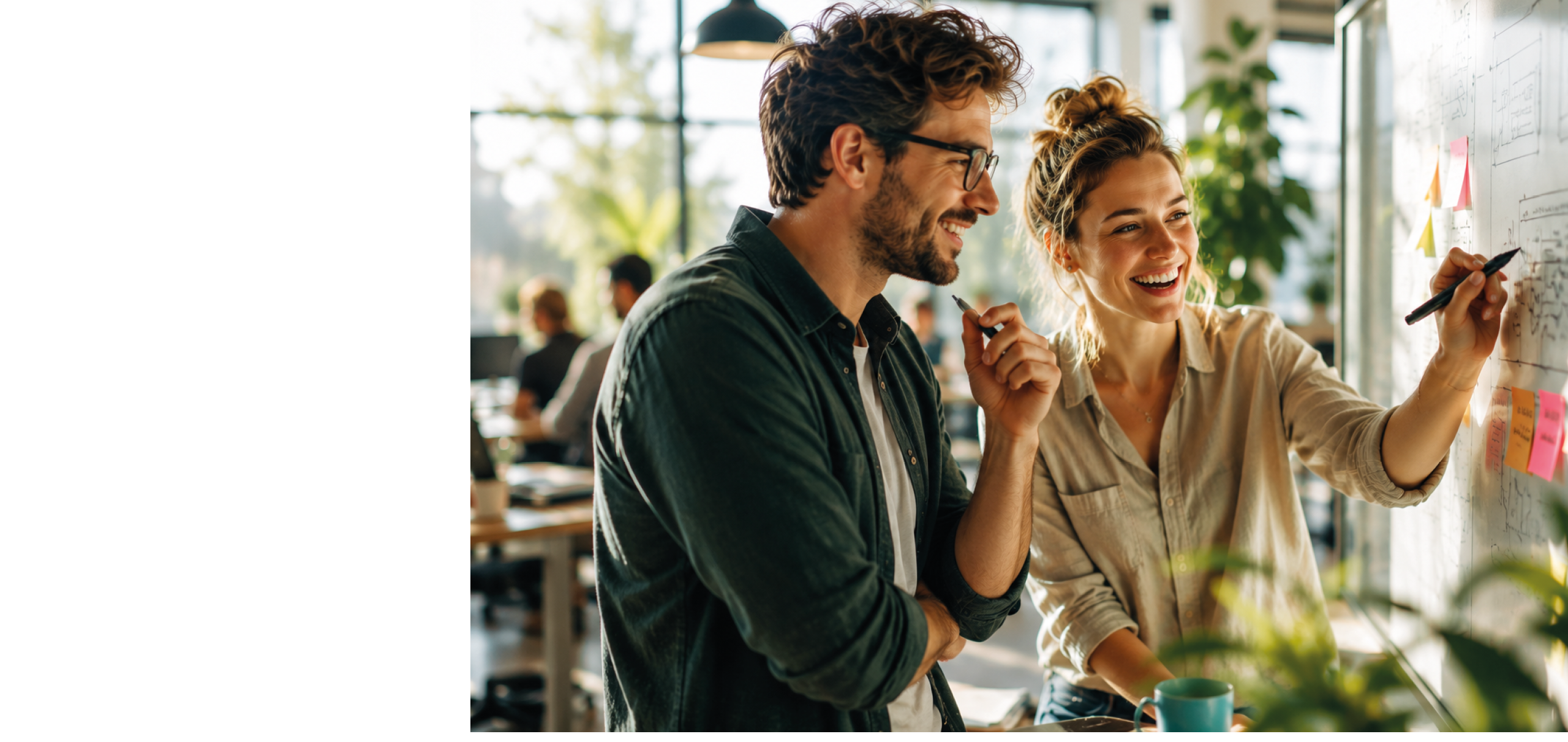 A man and a woman are standing in front of a white board. Description generated by AI