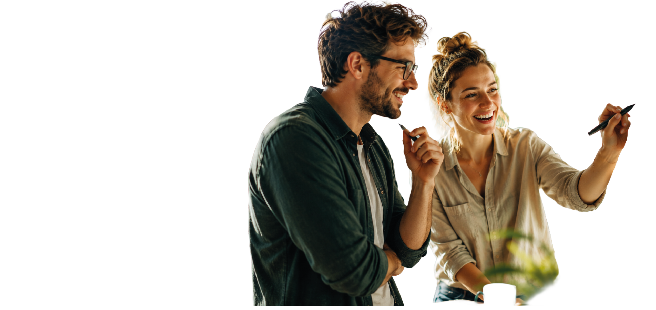 A man and woman are smiling and writing on a white board. Description generated by AI