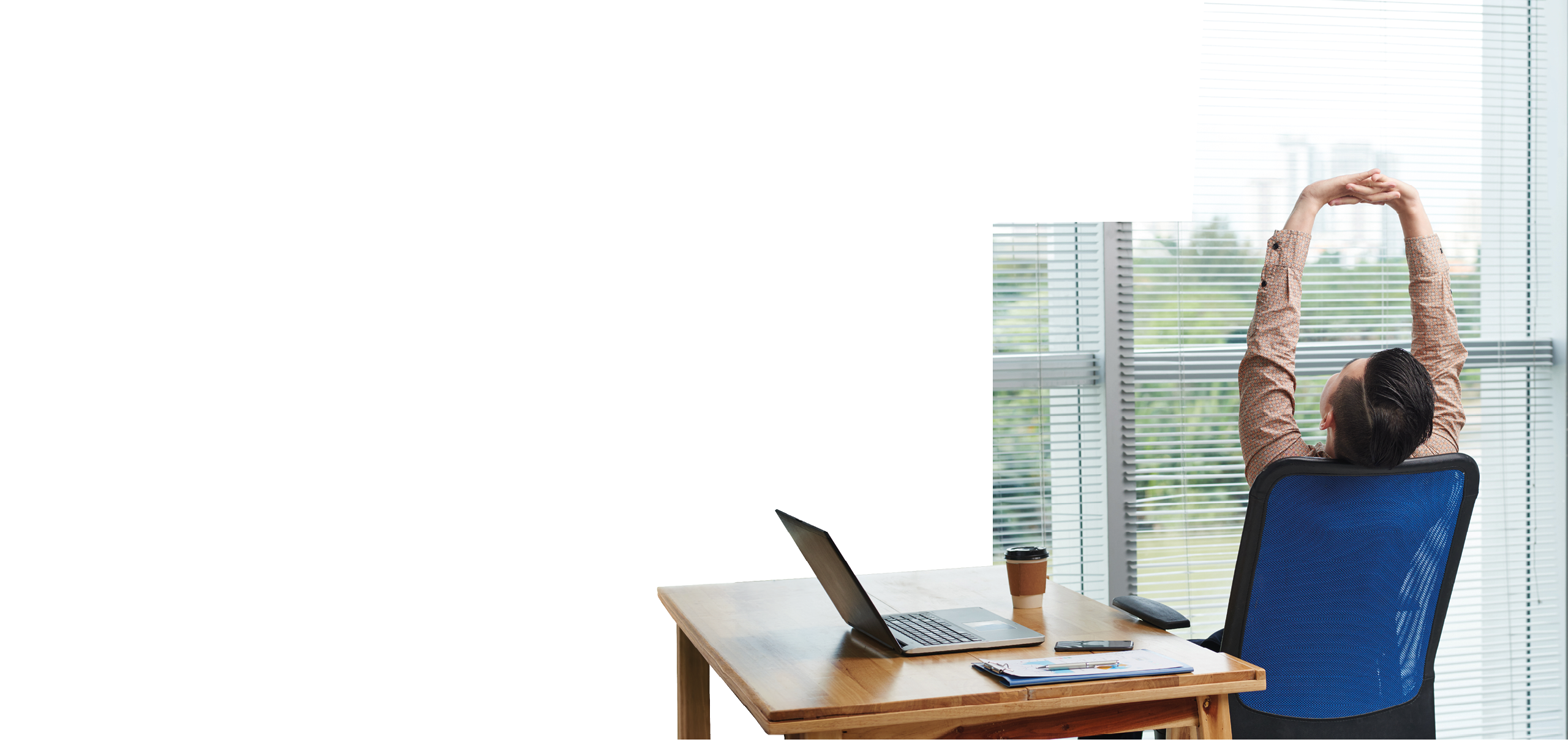 A woman is sitting in a blue chair with her arms up. Description generated by AI