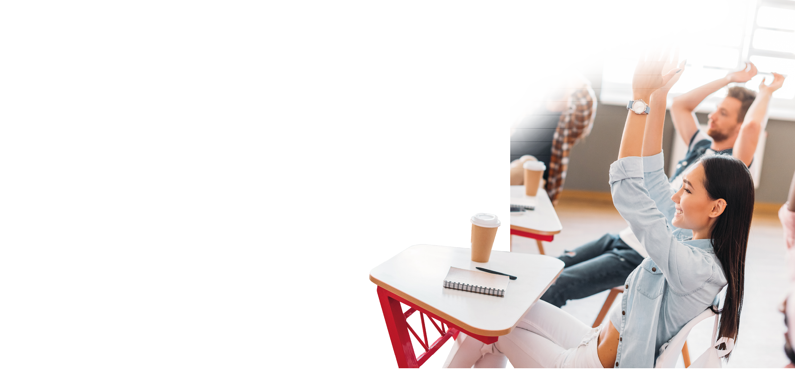 A woman is sitting at a desk with a cup of coffee in front of her. Description generated by AI