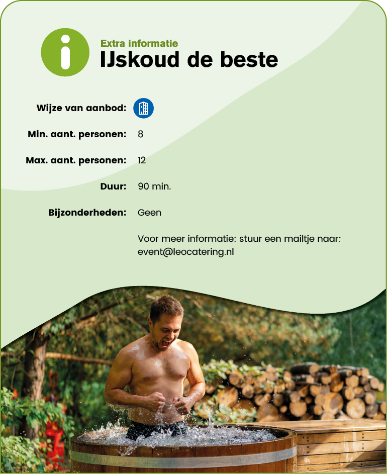 An adult with short hair is sitting in a wooden hot tub outdoors, splashing water with their hands and smiling, with a background of stacked firewood and greenery. Description generated by AI