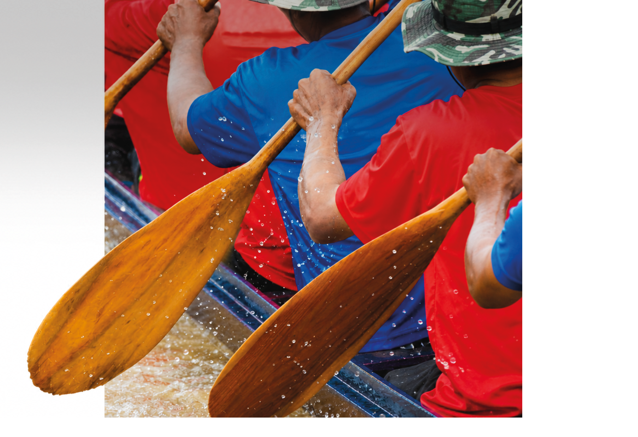 People wearing colorful shirts and hats are paddling a boat with wooden oars, splashing water around. Description generated by AI